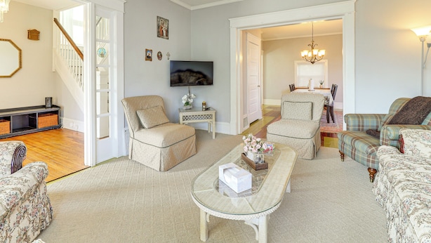 A spacious living room with a sofa, armchairs, a coffee table, and a television. - 1 Mi to Dtwn & Franciscan University: Home w/ Yard (Steubenville)