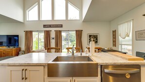 A kitchen with a large island, stainless steel appliances, and a sign reading "LAKE WAWASEE". - Lake Wawasee Family Getaway in Syracuse! (Syracuse)