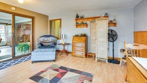 A cozy living room with a sofa, a wooden dresser, a fan, and a patterned rug. - Walk to Parks & Greenway: Sioux Falls Getaway! (Sioux Falls)