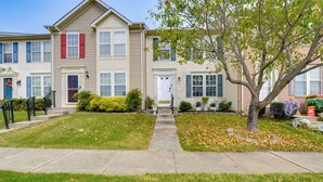 A row of townhouses with a central entrance, a small front yard, and a tree. - Close to Hospital & White Marsh! Rosedale Townhome (Rosedale)