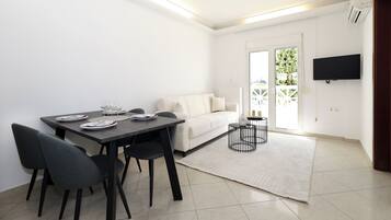 One Bedroom Apartment with Sea View | Living area | Flat-screen TV