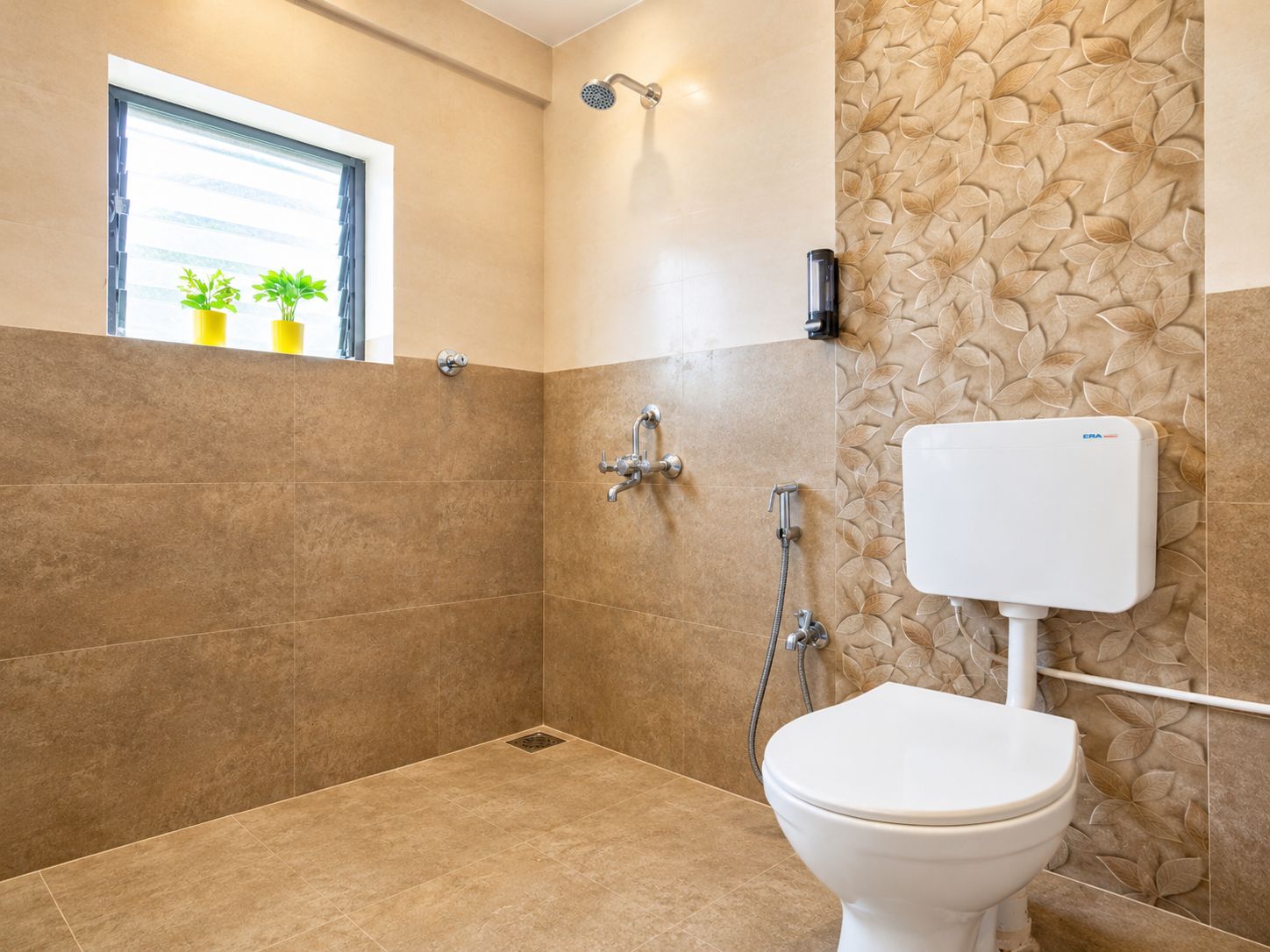 A bathroom with a shower, toilet, and a window with plants.