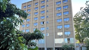 A multi-story building with numerous windows and air conditioning units, surrounded by greenery. - Three Couple Rooms | Breakfast Included | Near Iguazu Waterfalls (Parana)