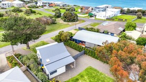 An aerial view of a residential area with houses, a road, and a view of the ocean. - 5 Rosetta Place, Hayborough (Hayborough)