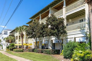 A multi-story hotel with balconies, outdoor seating, and palm trees. - Seagrove "Beachbound" 1BR, Sleeps 4, Gulf Views, Private Beach Access (Santa Rosa Beach)