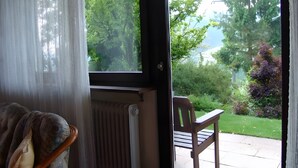 A room with a view of a garden, a chair, and a radiator. - Apartment Ritter with Panoramic Valley View and Private Terrace (Oberharmersbach)