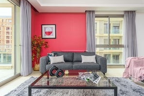 Apartment, 3 Bedrooms, Kitchen, City View | Living room | 55-inch Smart TV with cable channels, streaming services