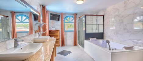 A modern bathroom with two sinks, a bathtub, and a shower.