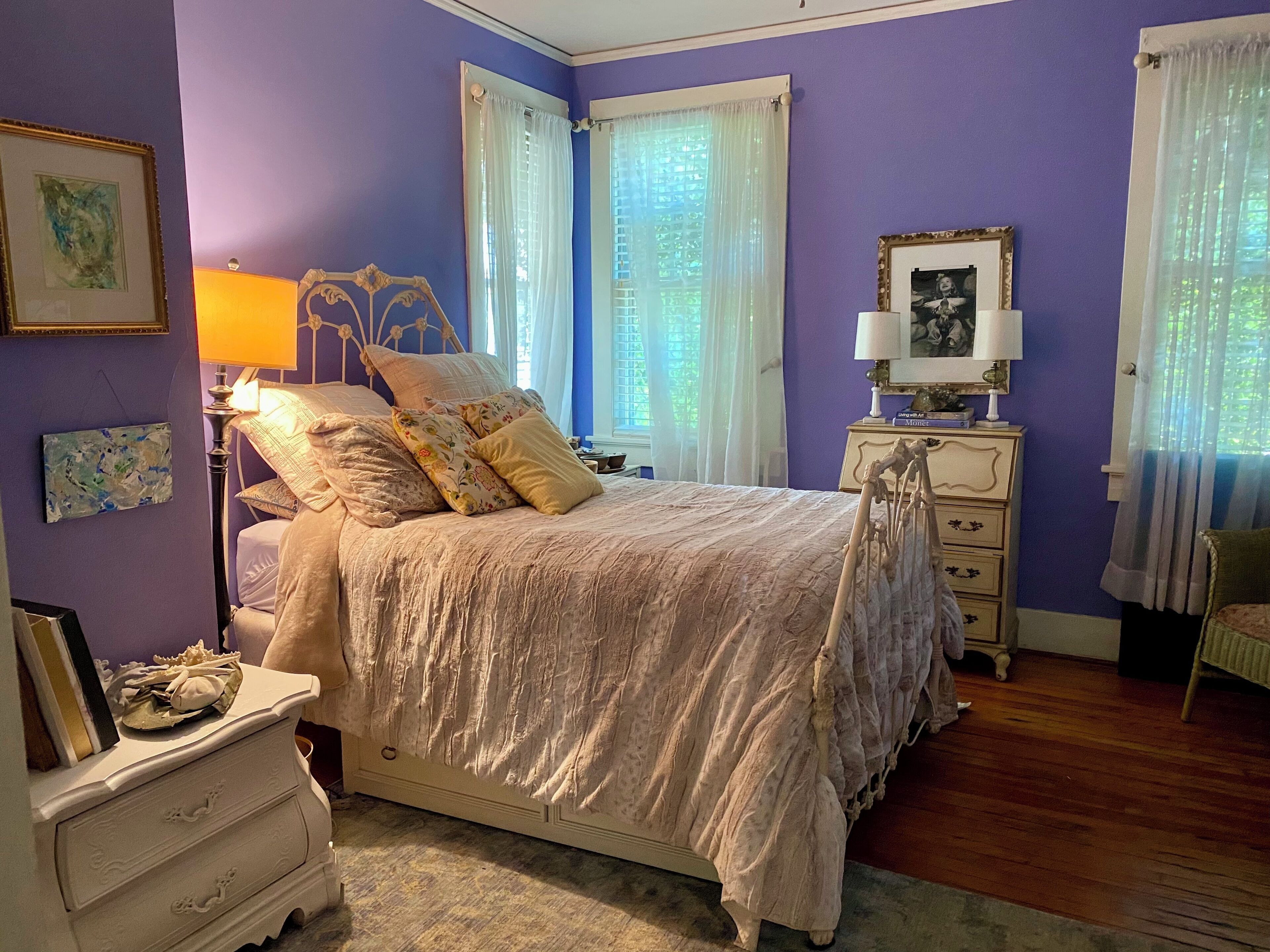 Une chambre à coucher comprenant un lit, une table de chevet, une commode et une chaise.