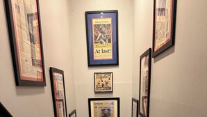 A staircase with framed sports memorabilia on the walls. - Luxury Townhouse near Downtown and Beaches with Hot Tub (Mount Pleasant)