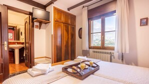A hotel room with a bed, a tray of breakfast, a bathroom, and a view of the outdoors. - The Village Retreat - Al Llagar (Sales)