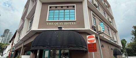 A multi-story hotel with a sign reading 'The Quay Hotel.'