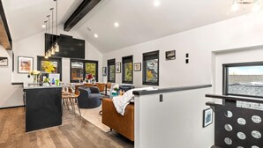 A modern interior with a dining area, kitchen, and seating space.