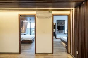 A hotel room with a bed, a bathroom, and a kitchenette.