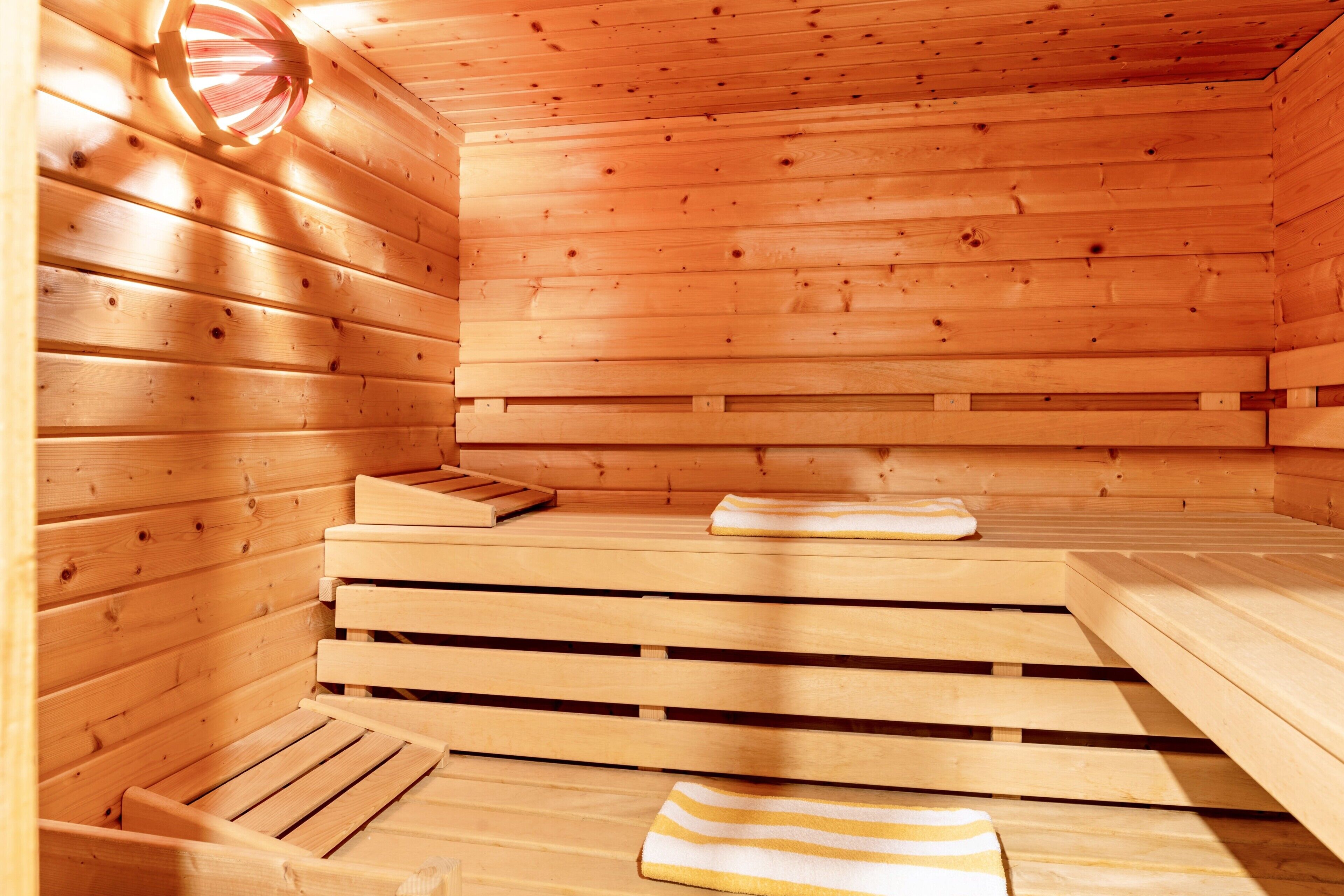 A wooden sauna with benches and a bench seat.