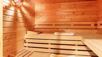 A wooden sauna with benches and a bench seat.