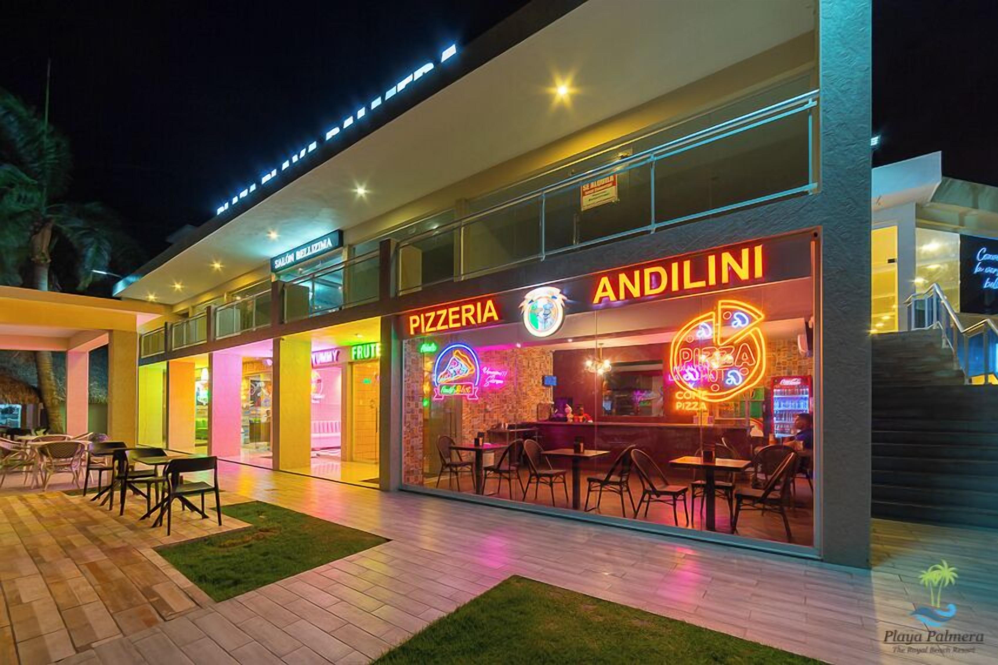 Moderni ulkoilmaravintola, jossa on Andilini-niminen pizzeria, ja jossa on käytetty neonvaloja sekä ulkotilojen istuimia.