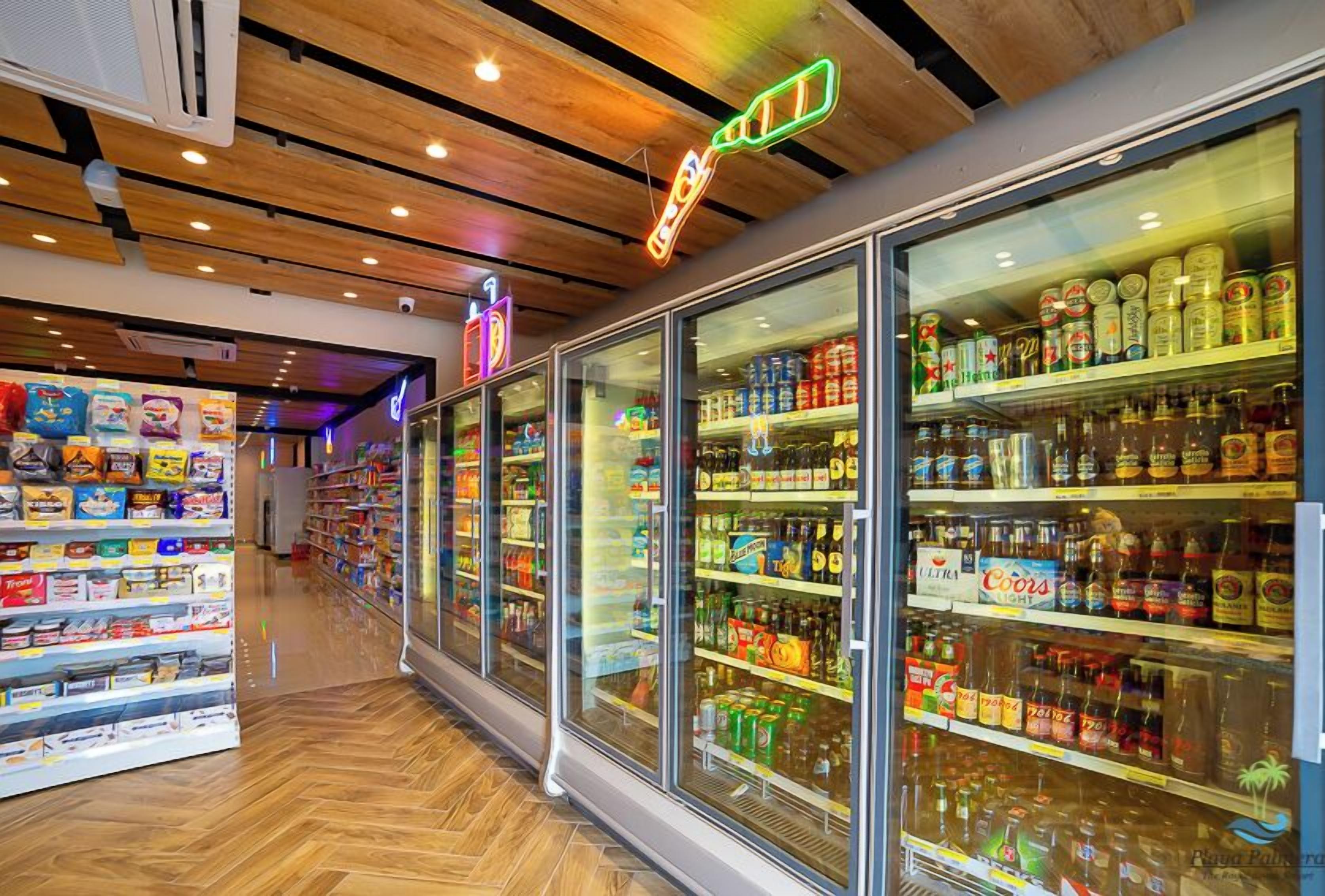 A store with refrigerated sections and shelves stocked with various products.