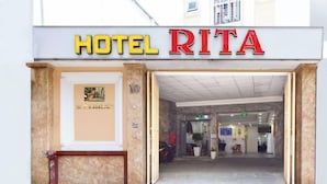 The entrance to Hotel Rita with a visible reception area and a number 10 sign on the door.