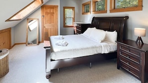 A bedroom with a bed, dresser, and a ceiling fan. There are windows and a skylight. - Hidden Kingdom in Plymouth (Plymouth)
