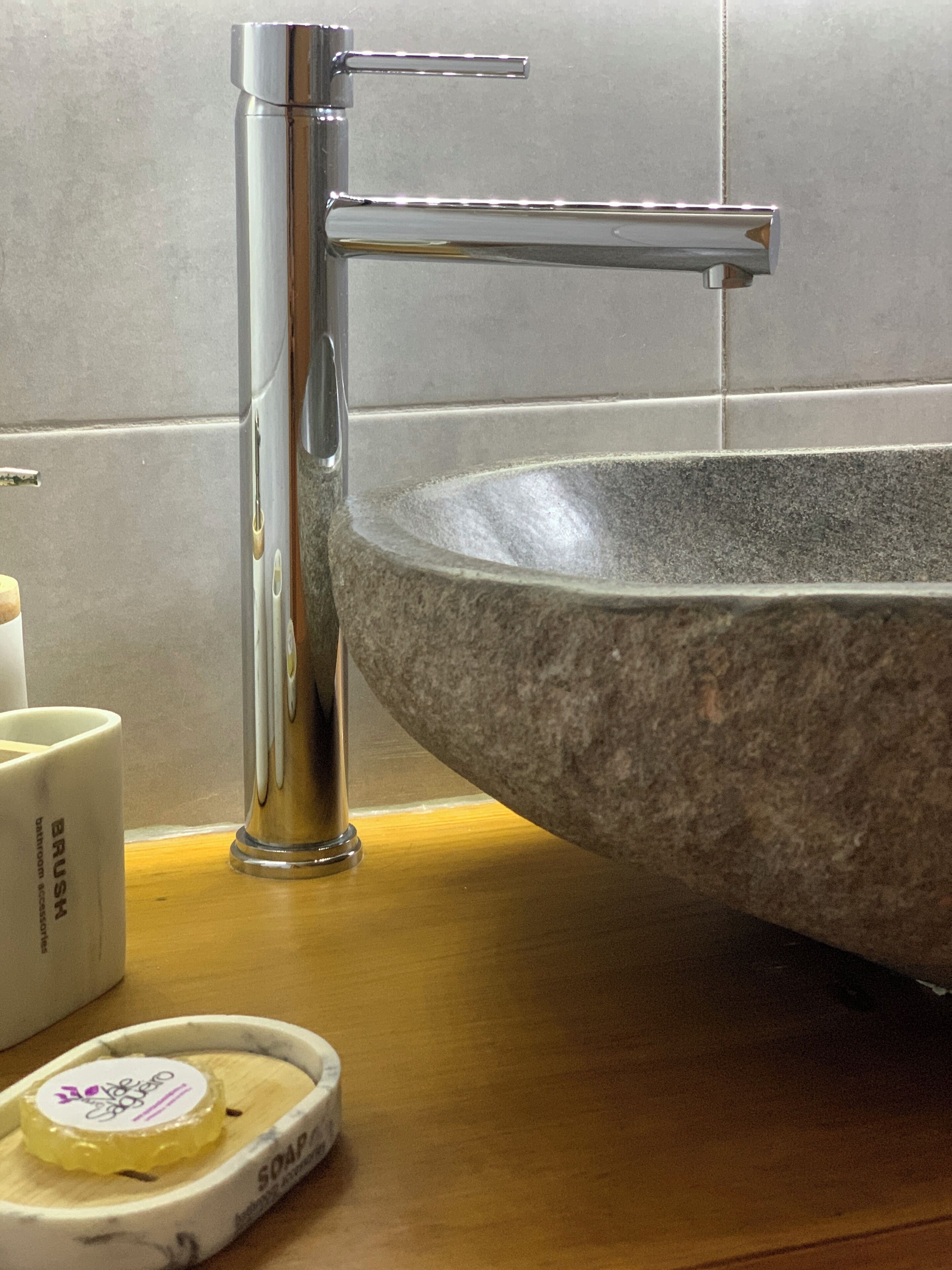 A bathroom sink with a granite basin and a chrome faucet.
