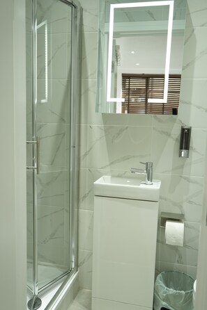 Superior Studio Suite, 1 King Bed | Bathroom | Shower, hair dryer, slippers, towels - Concept Rooms  (Enfield)