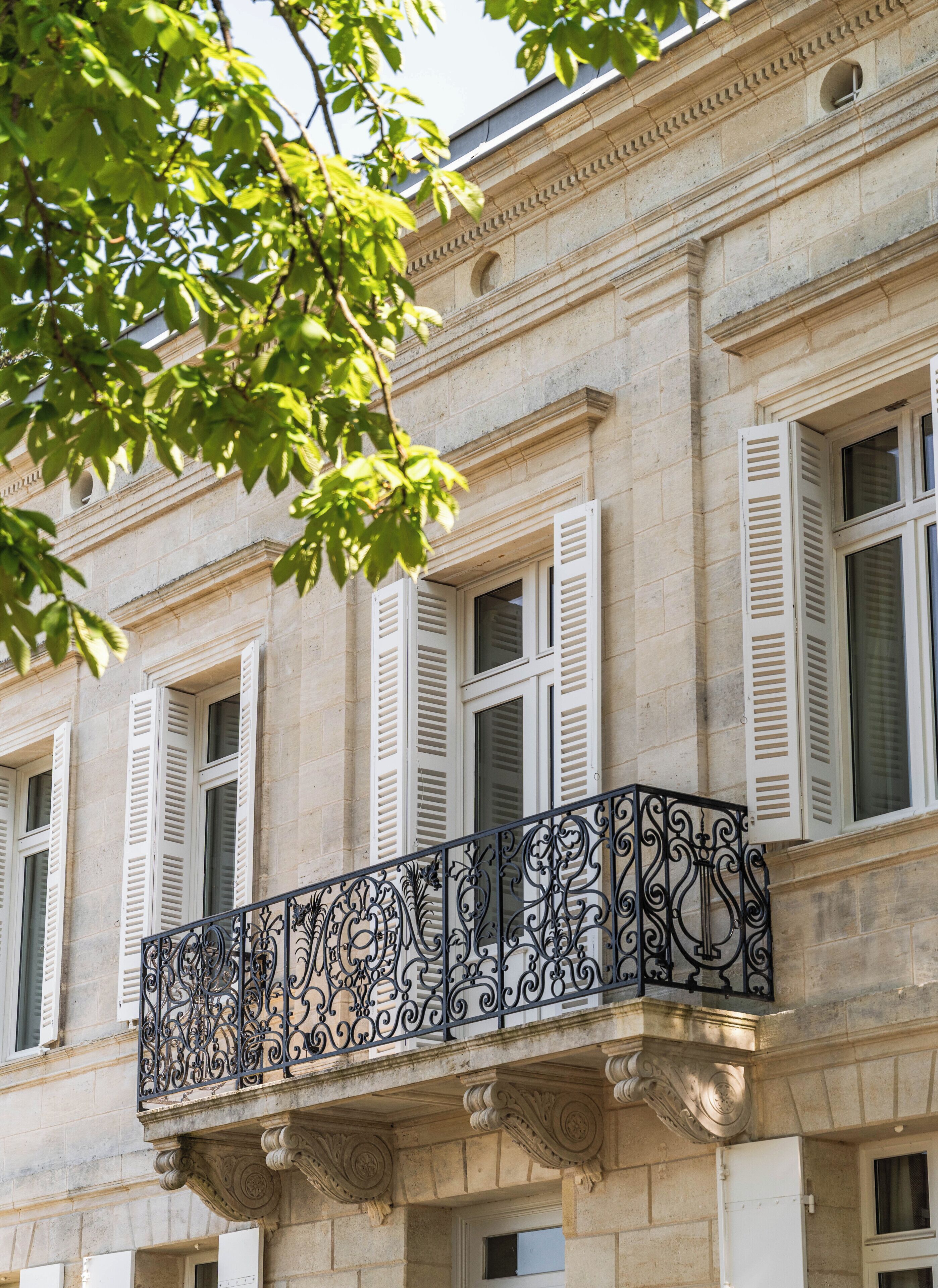 A building facade with classical architecture, including columns and decorative moldings.