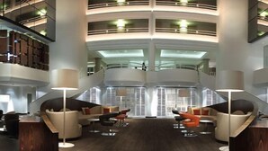 A modern interior with a central seating area, multiple levels, and a staircase. - AC Hotel by Marriott Ambassadeur Antibes - Juan Les Pins (Juan-les-Pins)