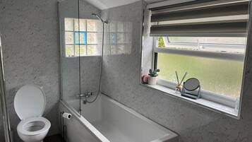 Combined shower/bathtub, deep-soaking bathtub, towels