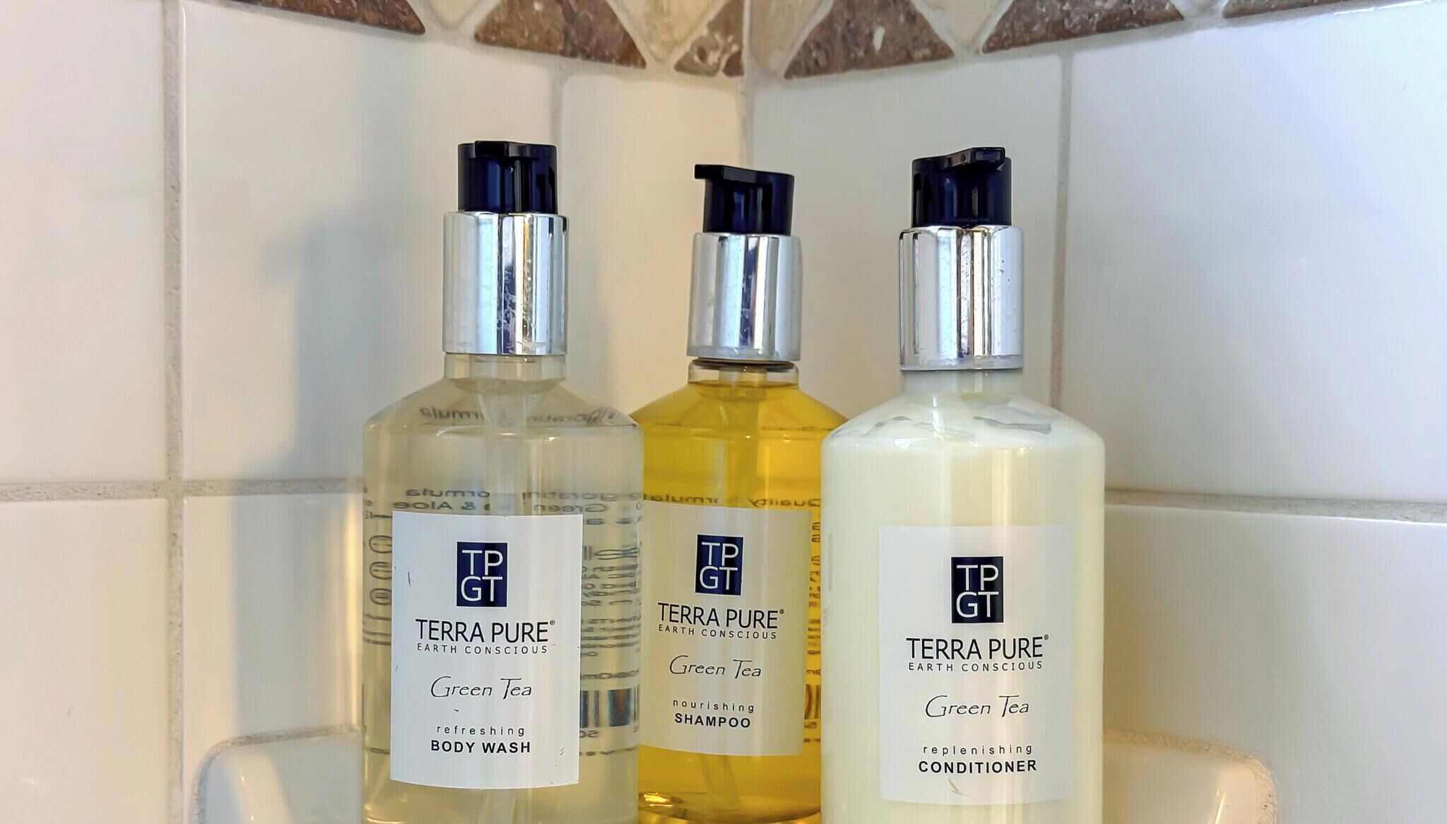 Three bottles of Terra Pure products on a tiled surface.