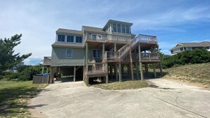 A two-story house with a deck and a garage.