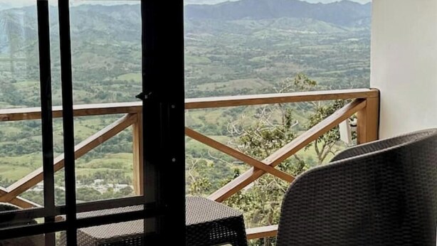 A balcony with a wooden railing overlooking a mountainous landscape. - Cabin in the mountains w/ Breakfast - Cabin 1 (Miches)