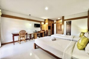 A hotel room with two beds, a desk, a chair, a television, and a wardrobe. - Ruentara Resort & Villa (Buri Ram)