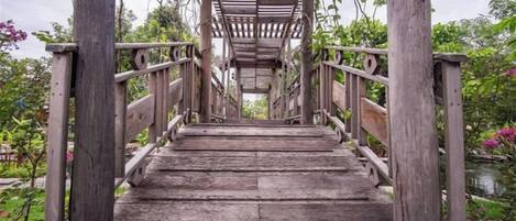 A wooden staircase leading up to a covered area with railings on both sides.