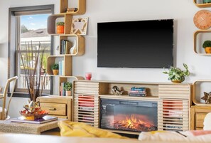Smart TV, fireplace, table football, books
