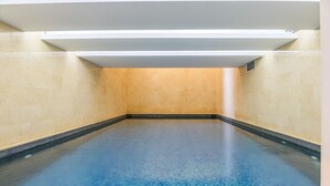 A large, empty swimming pool with a blue floor and beige walls. - Sirene 1-BR Apt Pool & Gym in Gemmayze (Beirut)