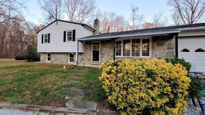 A two-story house with a stone facade and a garage.