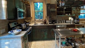 A modern kitchen with a skylight, stainless steel appliances, and a large window. - Charming 1-bedroom apartment - 38 Mins to NYC / Parking on site (New Rochelle)
