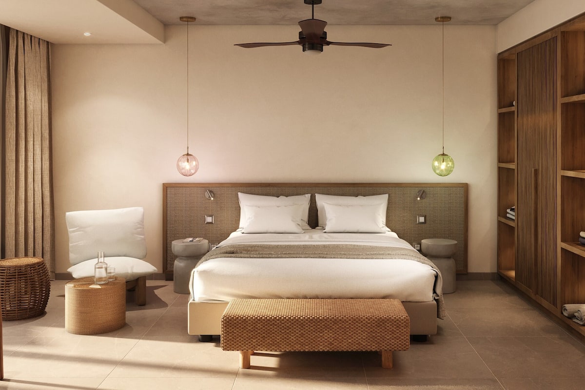 A modern bedroom with a large bed, bedside tables, a wardrobe, and a ceiling fan.
