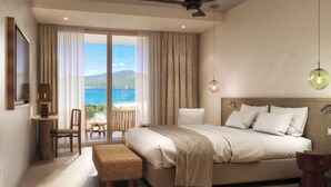 A modern hotel room with a large bed, a desk with a chair, a small table, and a view of the sea through a sliding door. - Casa C (Propriano)