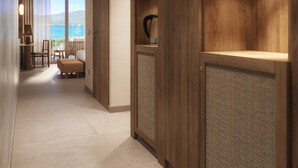 A hallway with wooden paneling and a view of a balcony with a table and chairs. - Casa C (Propriano)