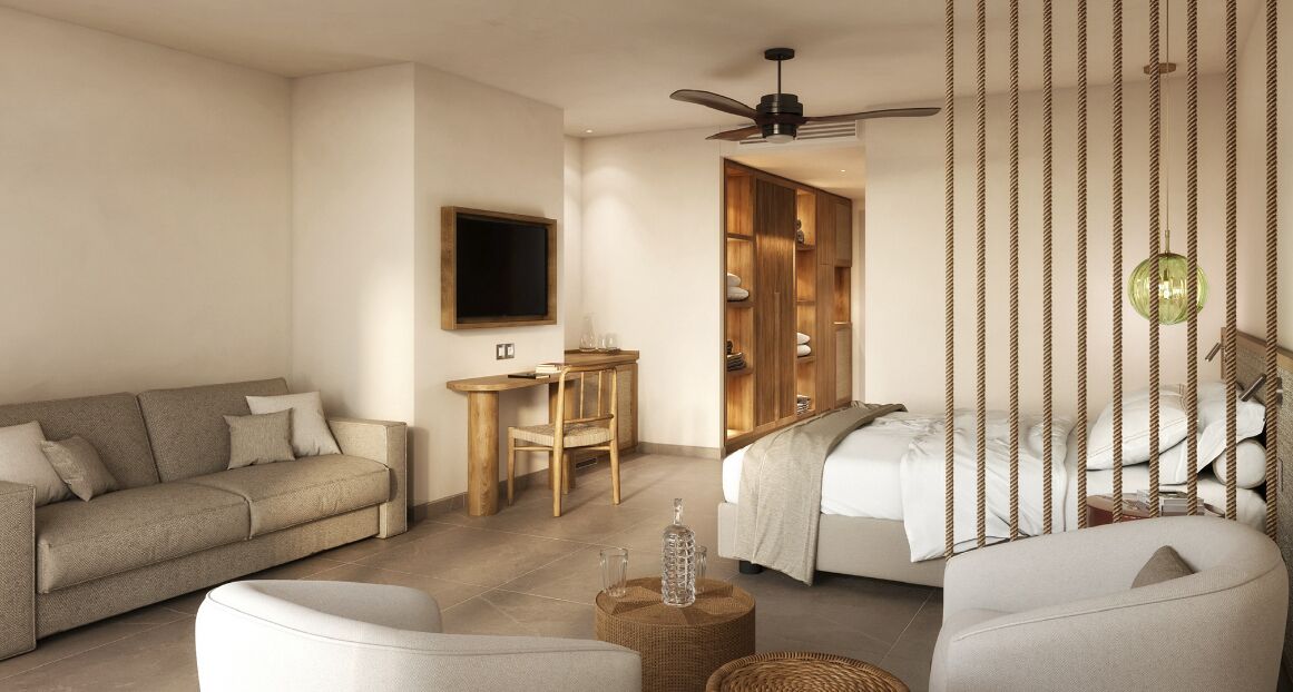A modern, well-lit room with a sofa, a bed, a TV, and a wooden wardrobe.
