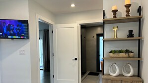 A modern bathroom with a shower, toilet, and sink. - Modern Waterfront home w/ Game Room & Private Dock (Cape Coral)