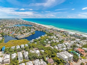 A coastal residential area with houses, a marina, and a beach.