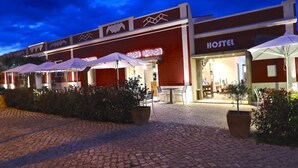 A hotel with outdoor seating and a restaurant named 'Legua Iberica'. - Lost & Found Hostel & Suites (Albufeira)