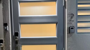 A gray door with a keypad lock and a number 2 on the wall beside it. - A&E L.A. Rental Apartments #2 (Carolina)