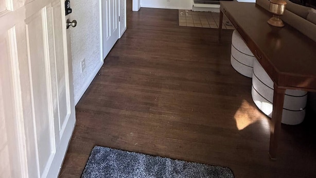 A spacious living area with a fireplace, wooden flooring, and a dining table. - Charming SE ICT Home 3 Bedrooms/2 Baths/2 Queens/1 Twin/1 Queen Pullout (Wichita)