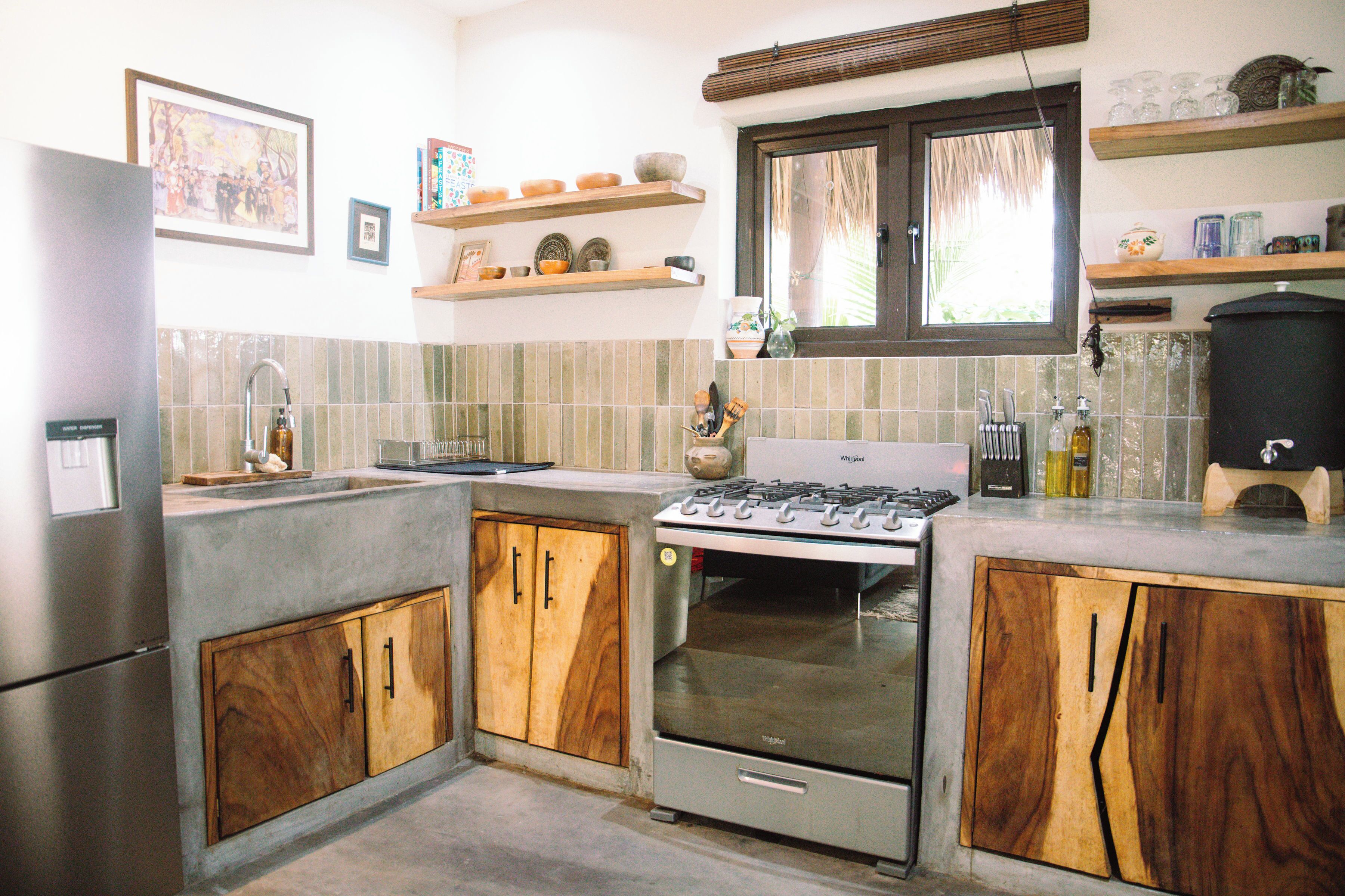 A kitchen with wooden cabinets, a gas stove, and a built-in oven.