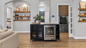 A modern kitchen with a built-in refrigerator, wooden cabinets, and a stainless steel oven. - The Executive Retreat at Westberry (Madera)