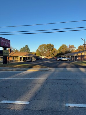 A street view with a building labeled "Executive Inn" and a sign for "Free WiFi Micro Fridge." - The Executive Inn (Danville)